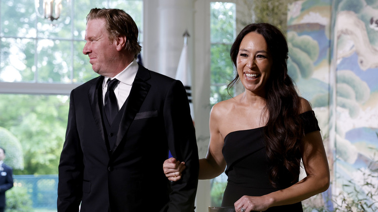 Chip and Joanna Gaines wear formal attire and smile at a White House function in 2023.