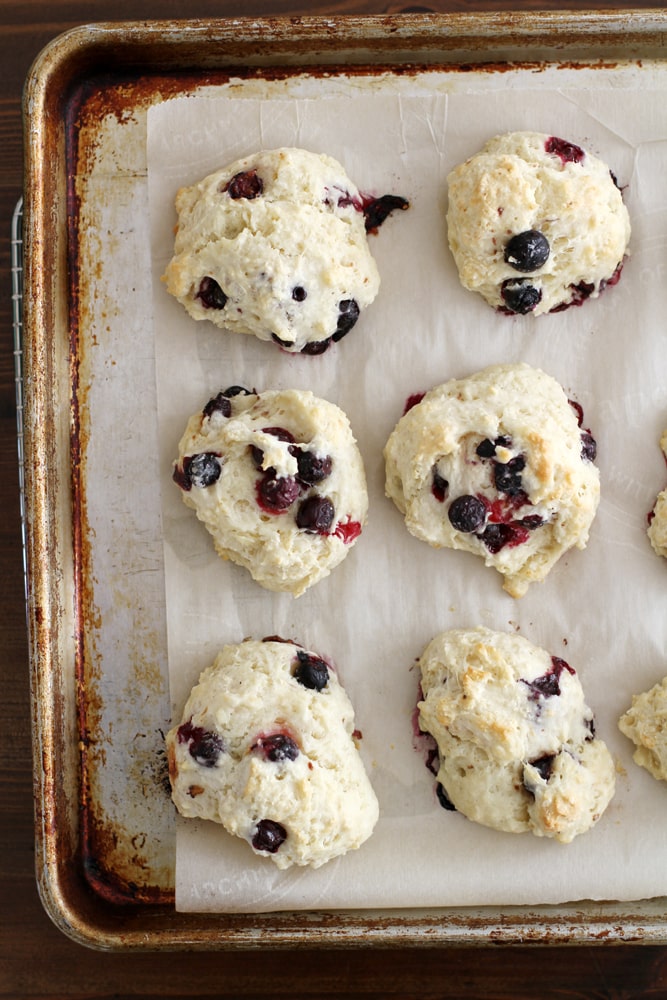 blueberry buttermilk drop biscuits on a baking sheet