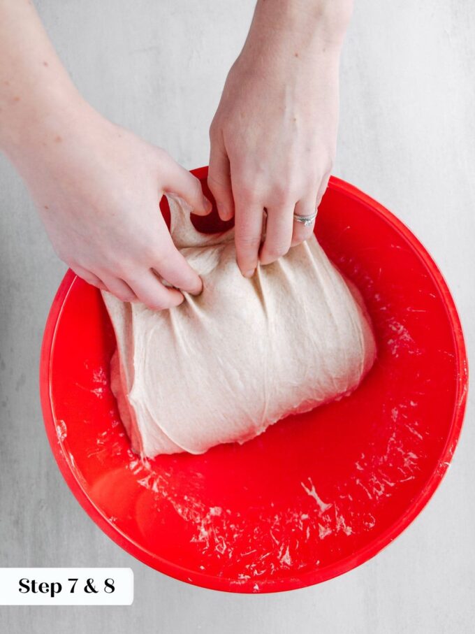 folding sourdough bread dough in red bowl.