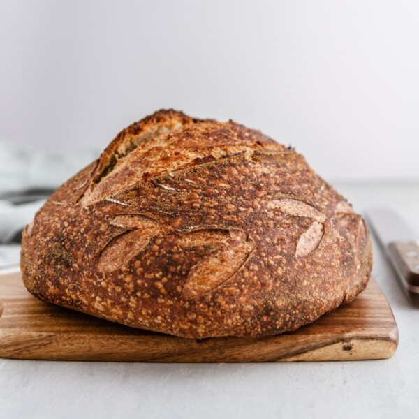 baked sourdough loaf with ear beautiful scoring detail.