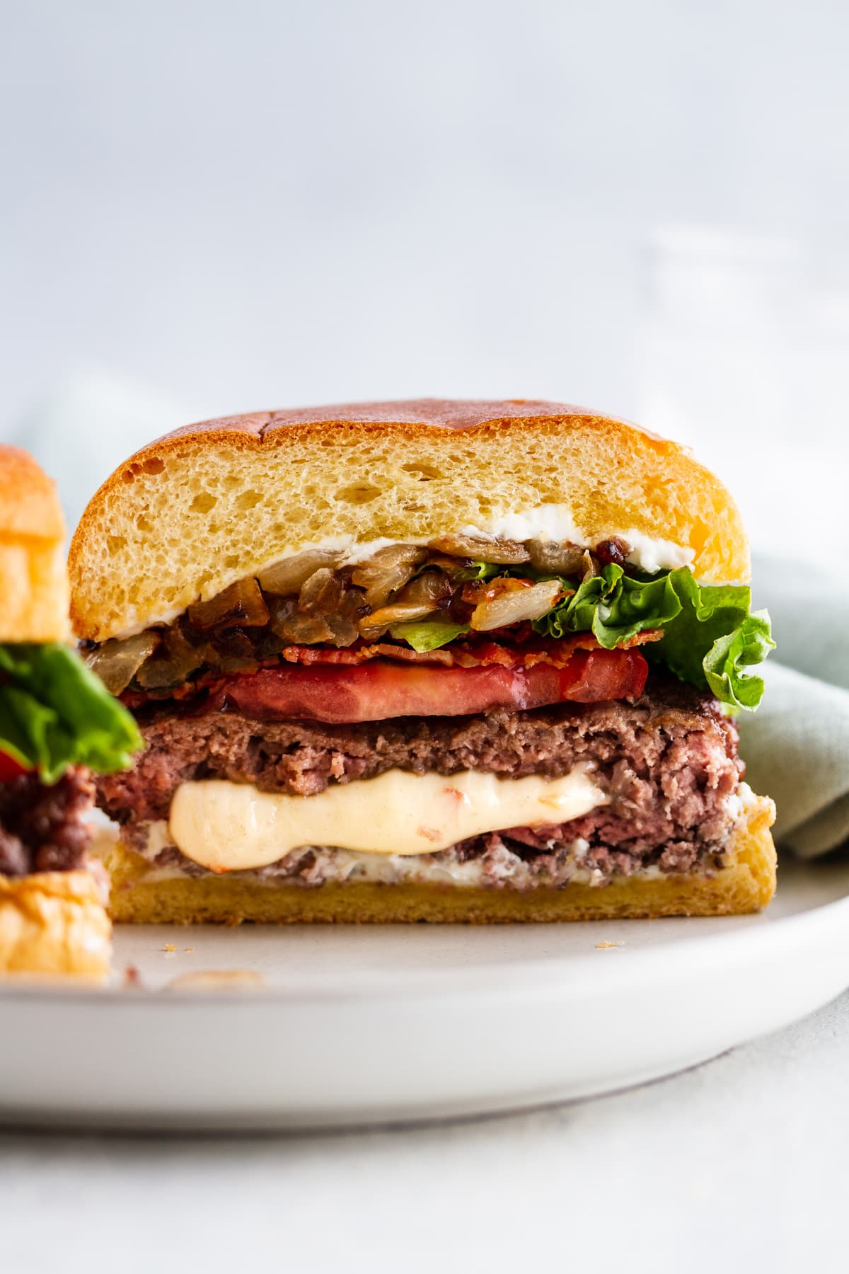 a pepper jack juicy lucy burger cut in half on a plate