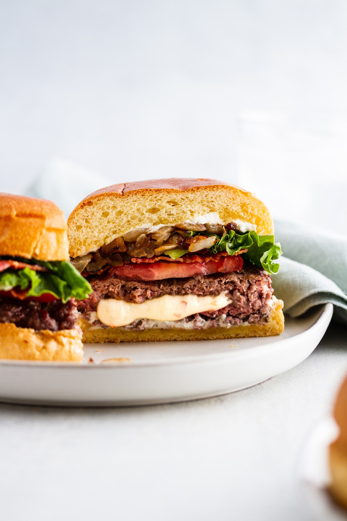 a pepper jack juicy lucy burger cut in half on a plate