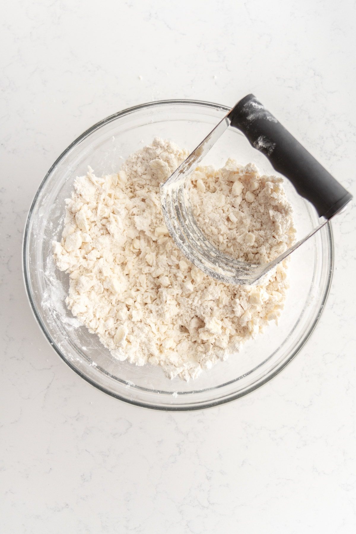 butter and flour in a bowl with a pastry blender.