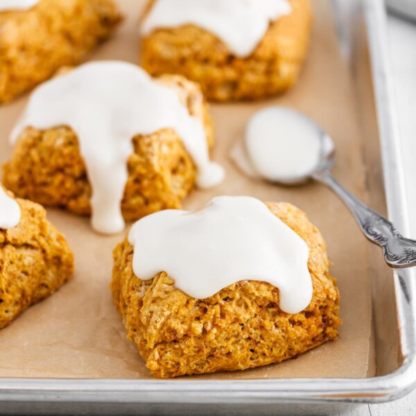 sweet potato biscuits on a baking sheet with marshmallow icing.