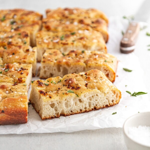 slices of focaccia bread viewed from the side on white parchment.