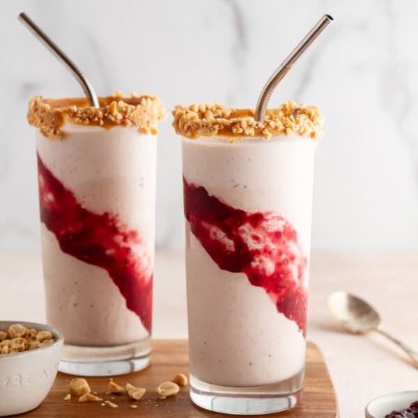 peanut butter and jelly milkshakes on a cutting board.