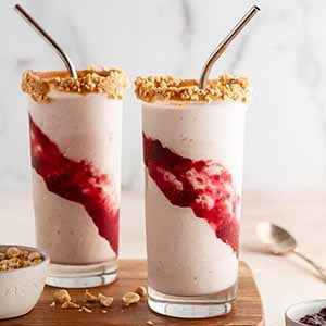 peanut butter and jelly milkshakes on a cutting board.