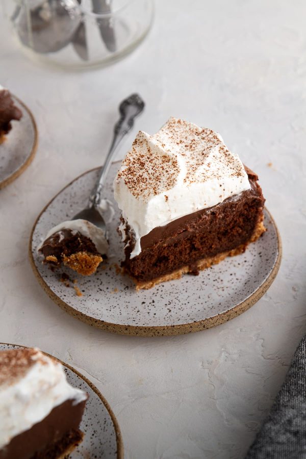 a slice of mississippi mud pie on a plate with a bite taken out of it