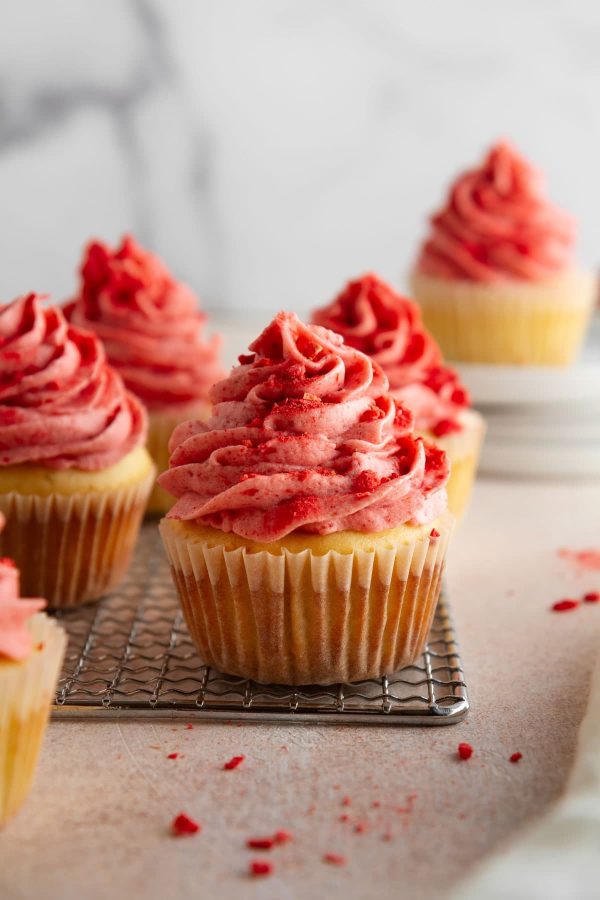 strawberry shortcake cupcakes on a cooling rack