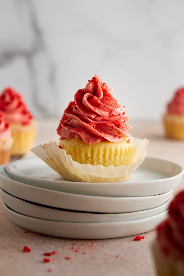 strawberry shortcake cupcake on a stack of plates