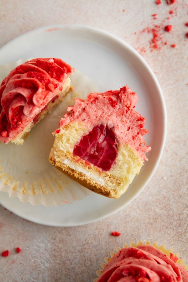 strawberry shortcake cupcake cut in half on a plate