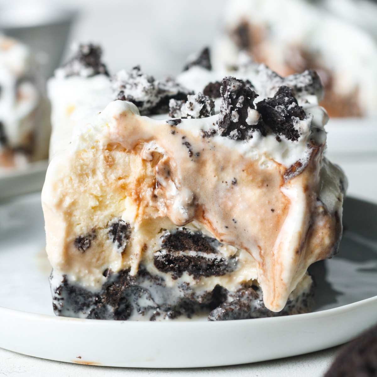 slice of oreo ice cream cake on plate melting.