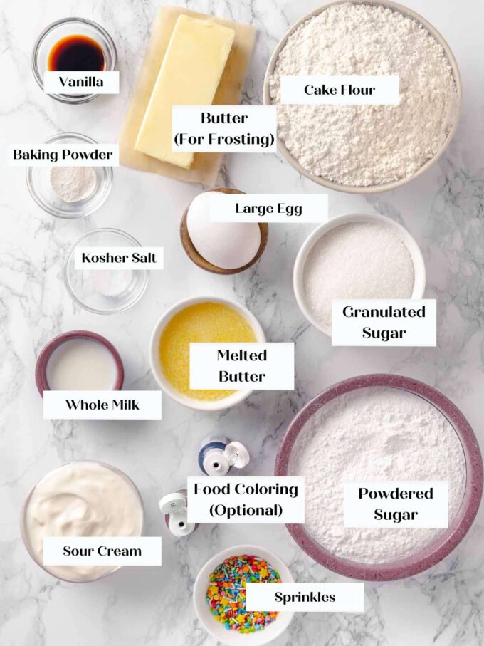 frosted sugar cookies ingredients on marble.