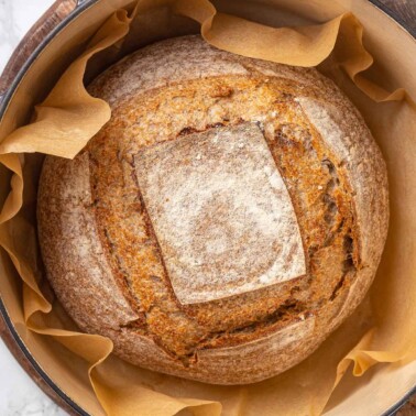 baked whole wheat sourdough in dutch oven.