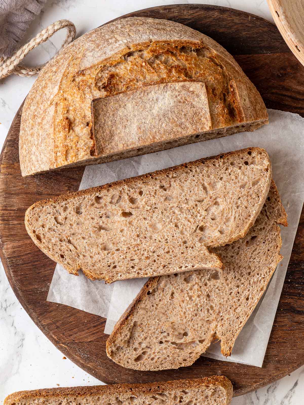 sliced whole wheat sourdough on wooden board.