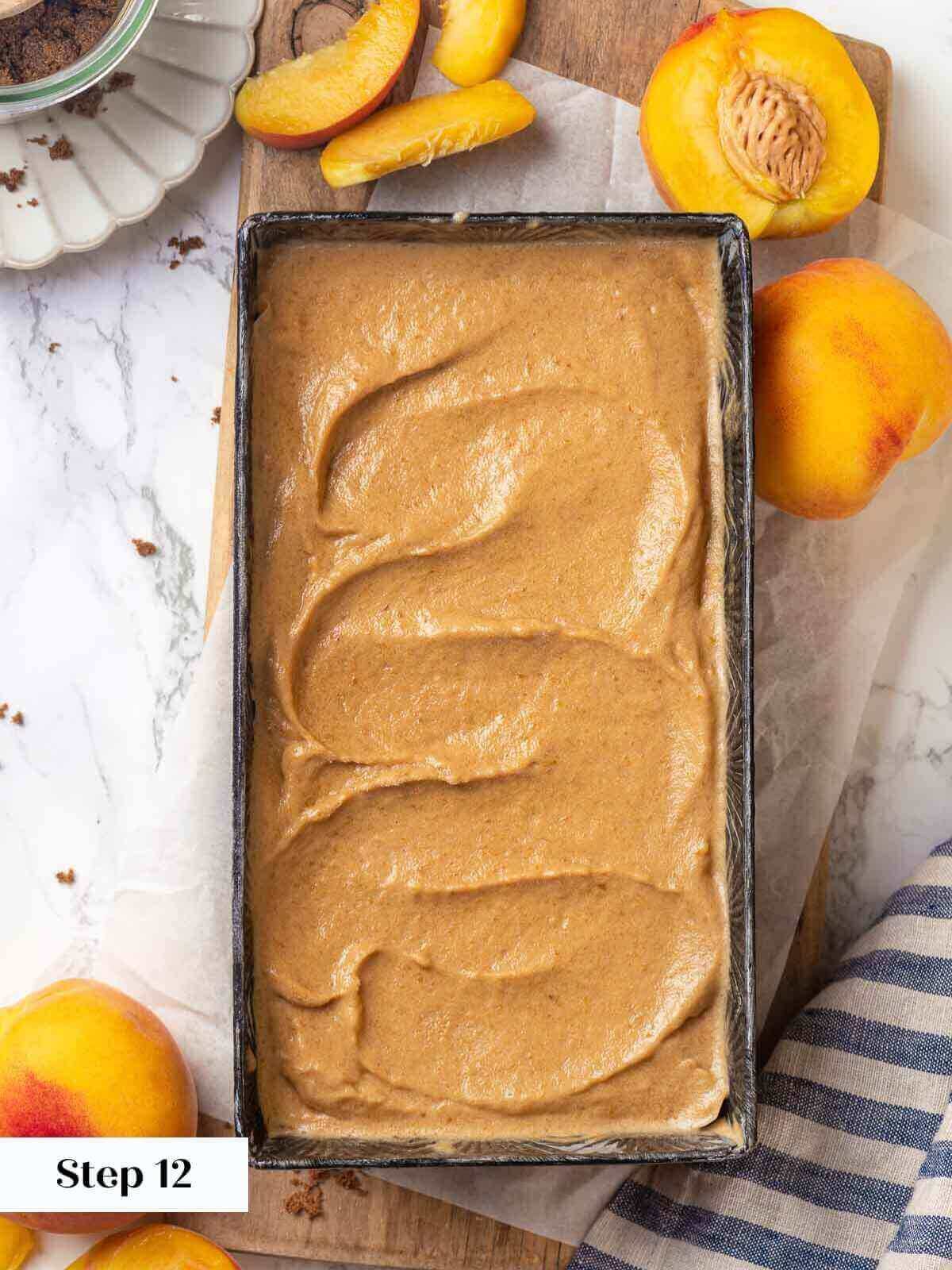 Peach ice cream process in a metal container.