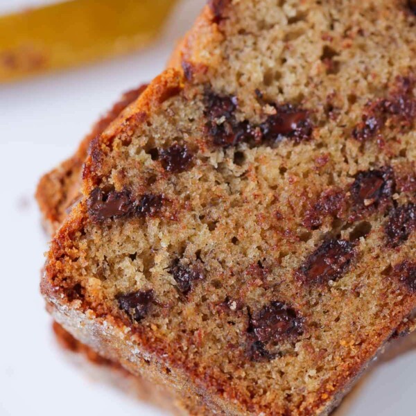 Chocolate chip banana bread with a golden crust slice.