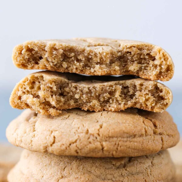 A single cookie broken in half to reveal its chewy and moist interior.