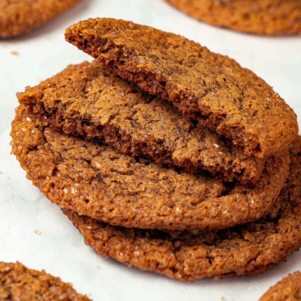 A molasses cookie broken in half to showcase its chewy interior.