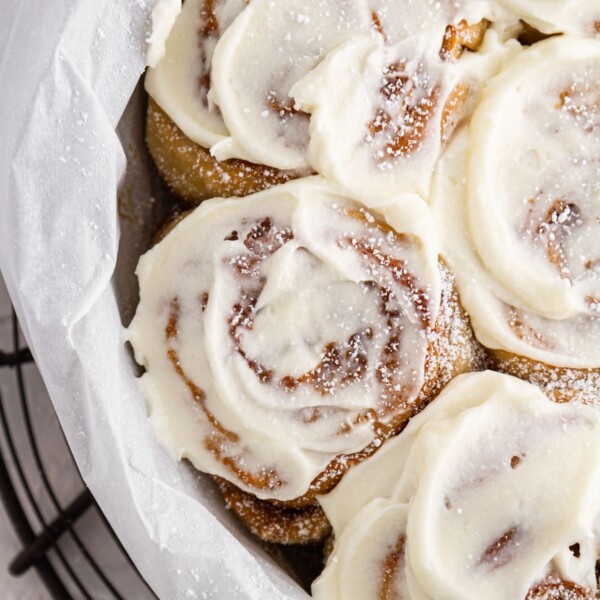 close-up shot of sourdough cinnamon rolls in pan.