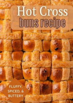 A tray of golden-brown hot cross buns, fresh out of the oven.