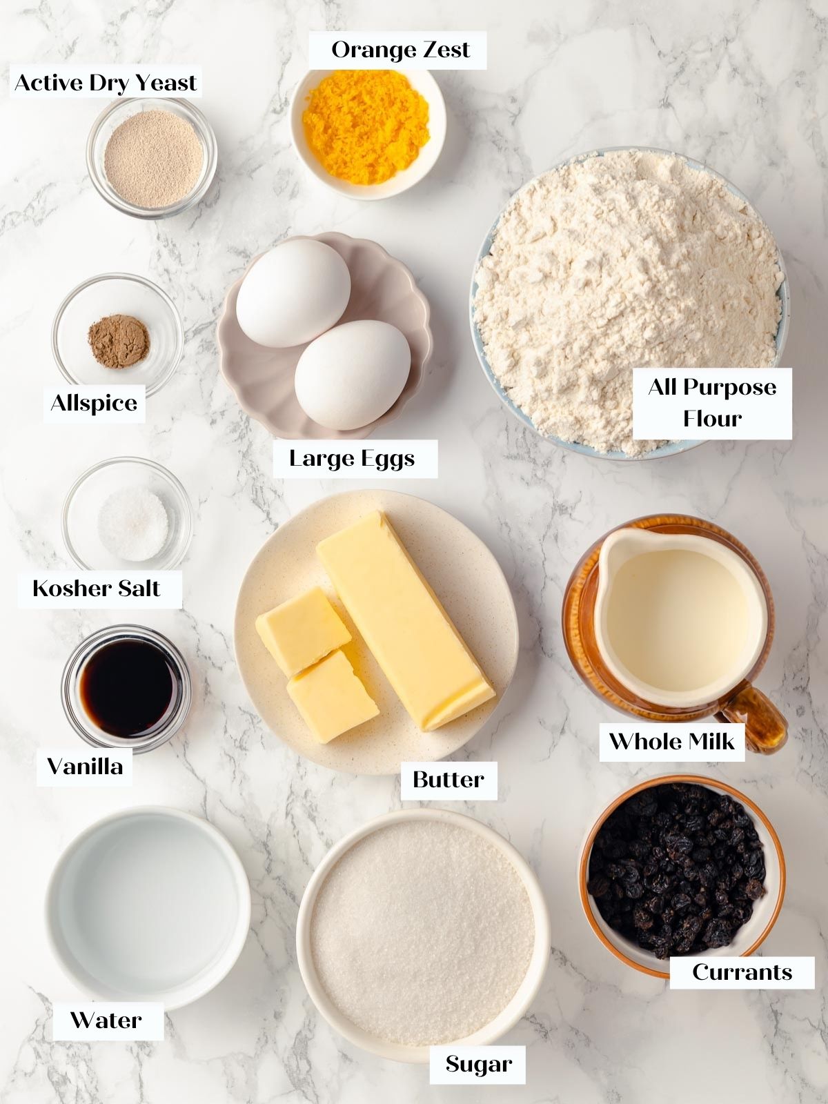 All the ingredients for hot cross buns laid out on a countertop.