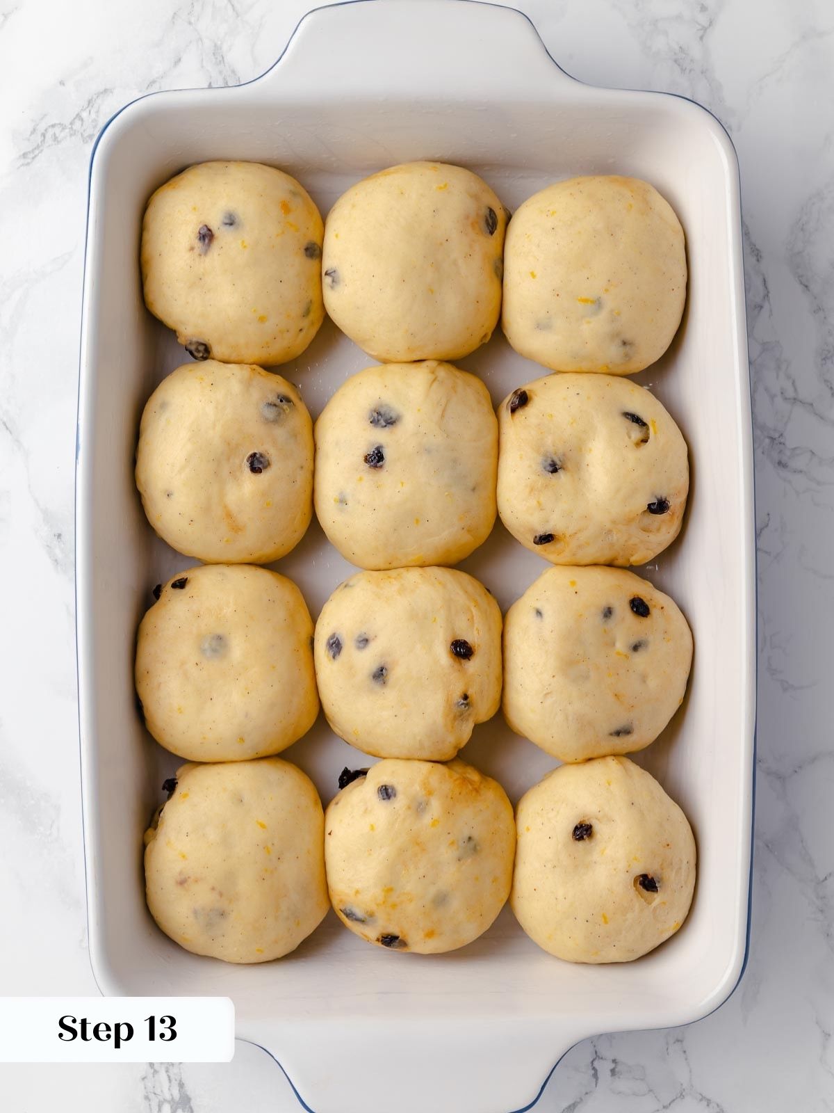 Fully proofed hot cross buns, ready for baking.