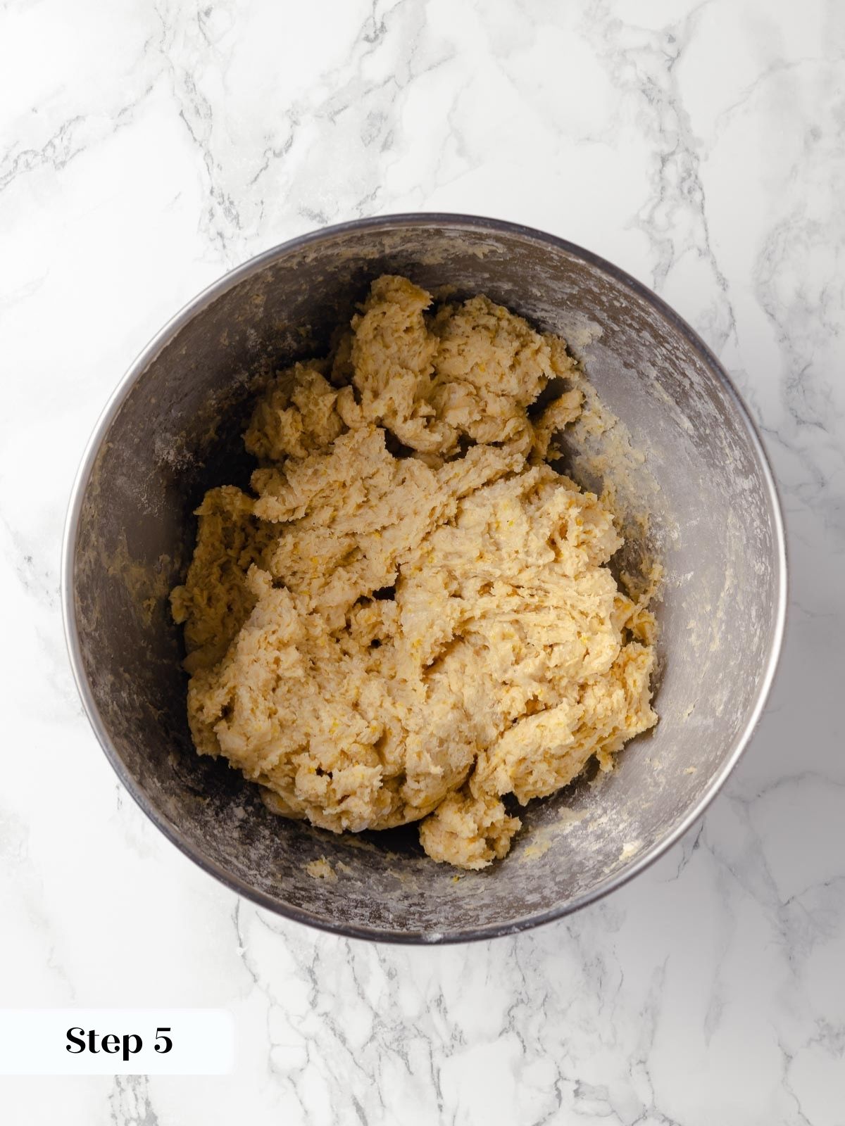 Flour and yeast mixture being combined in a mixing bowl.