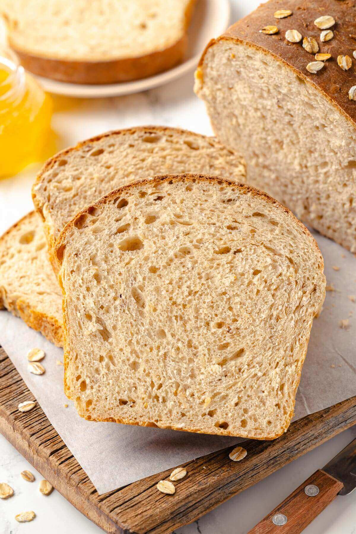 Several pieces of oatmeal bread arranged casually on the board.