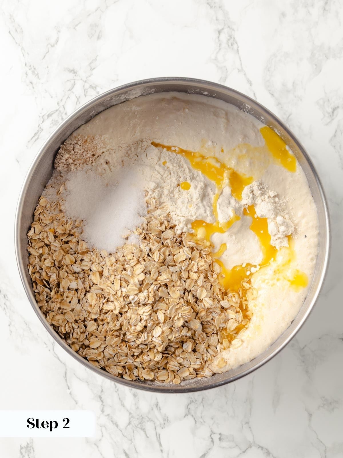 Pouring oats into a bowl with flour for the dough.