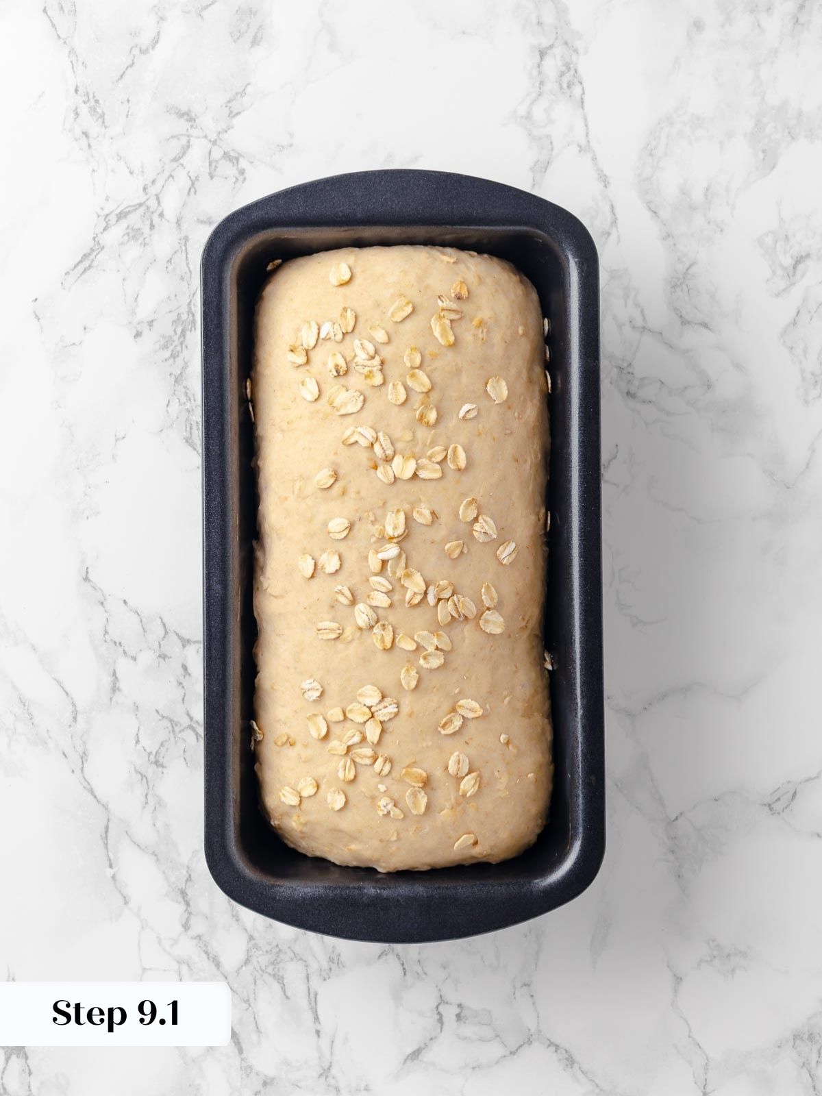 Fully proofed oatmeal bread dough in a loaf pan.