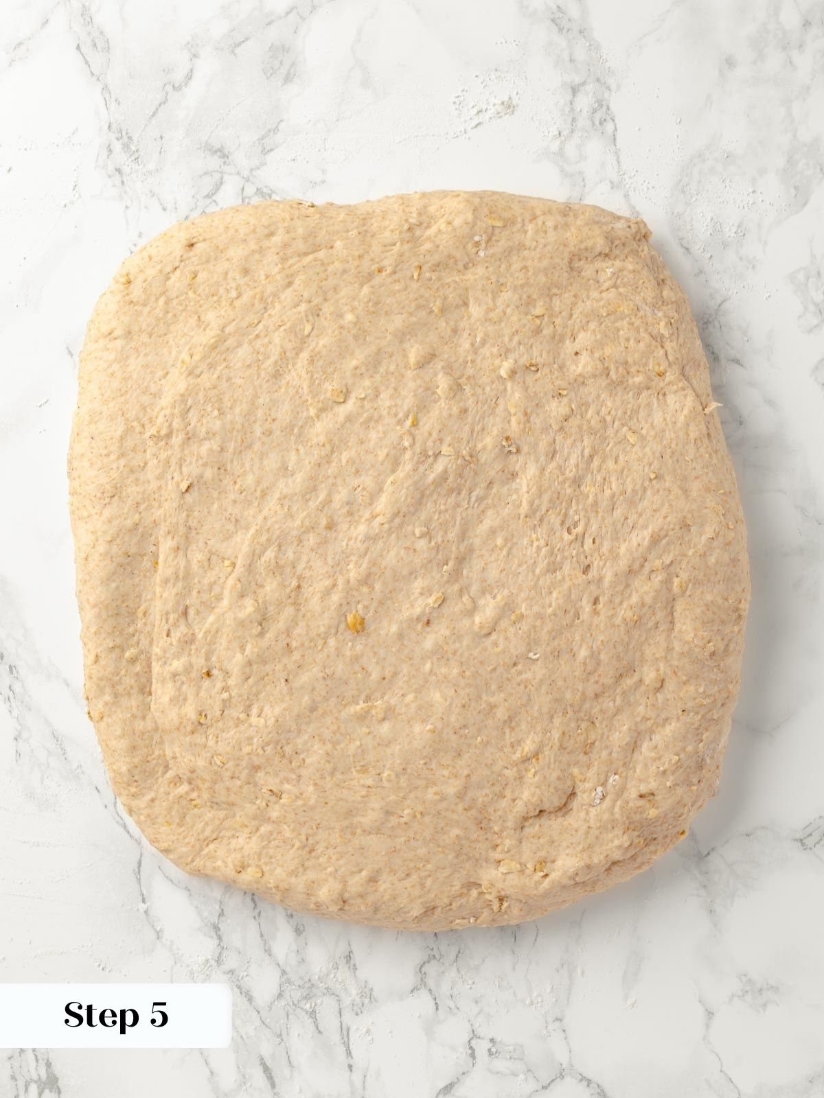 Folding stage of bread shaping before forming the loaf.