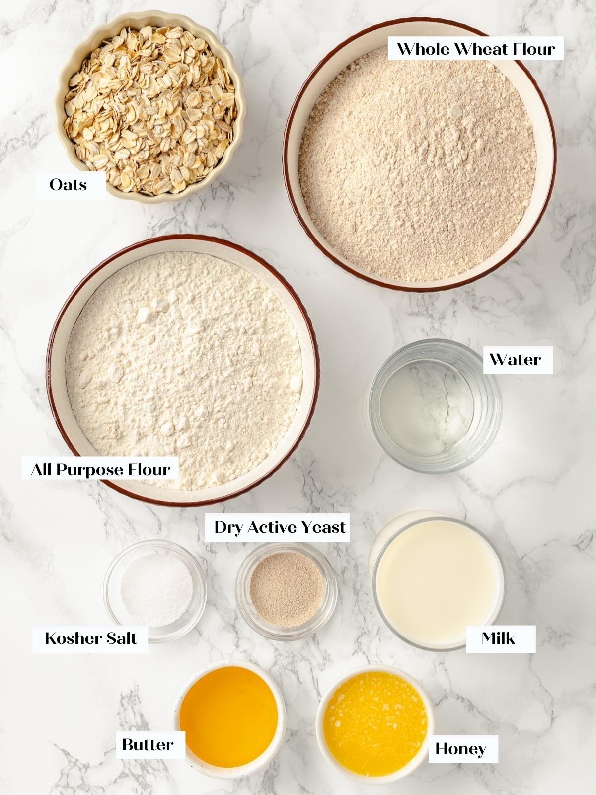 All ingredients for oatmeal bread laid out on a countertop.