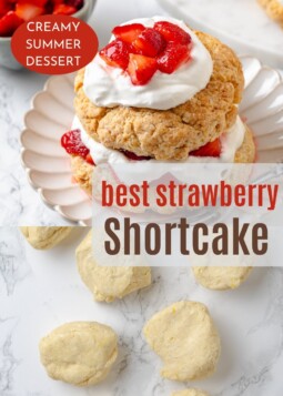 Close-up of golden shortcake topped with macerated strawberries and cream.