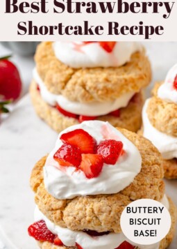 Dollop of whipped cream spooned over a shortcake half with fresh berries on top.