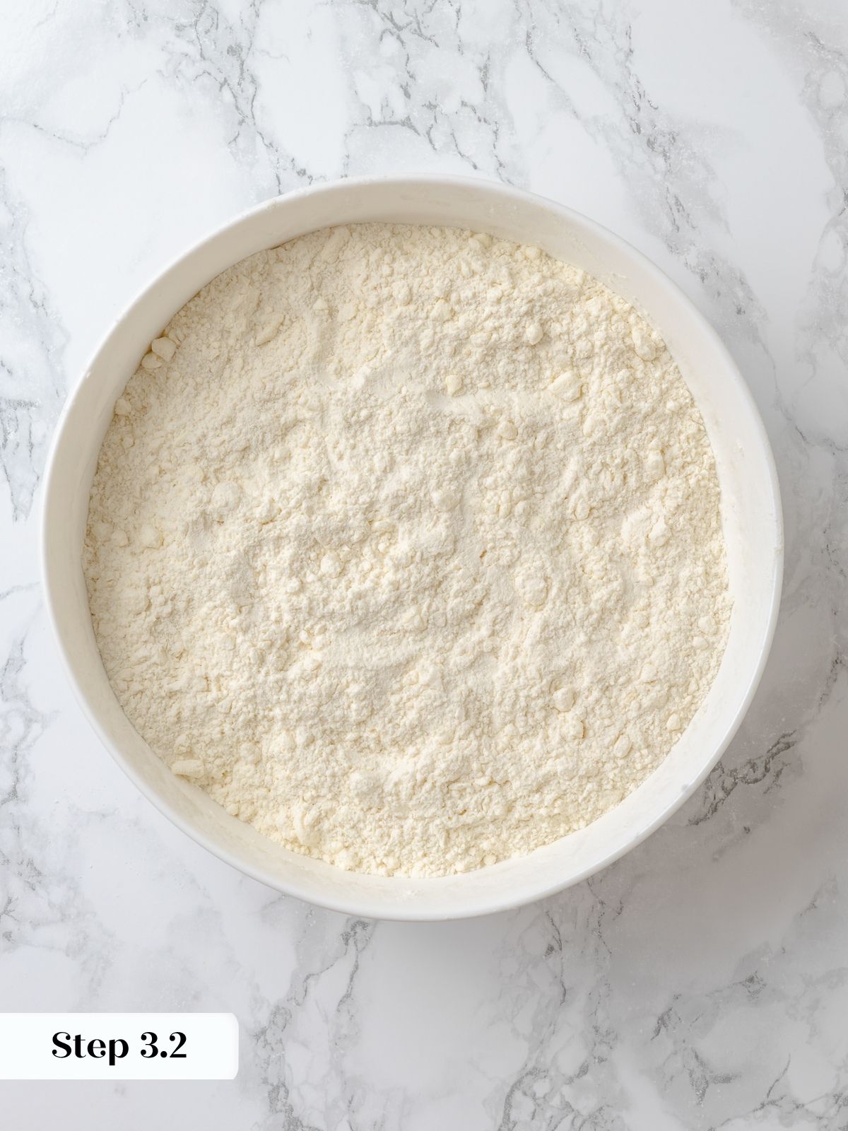 Butter in flour mixture crumbled to the size of small peas.