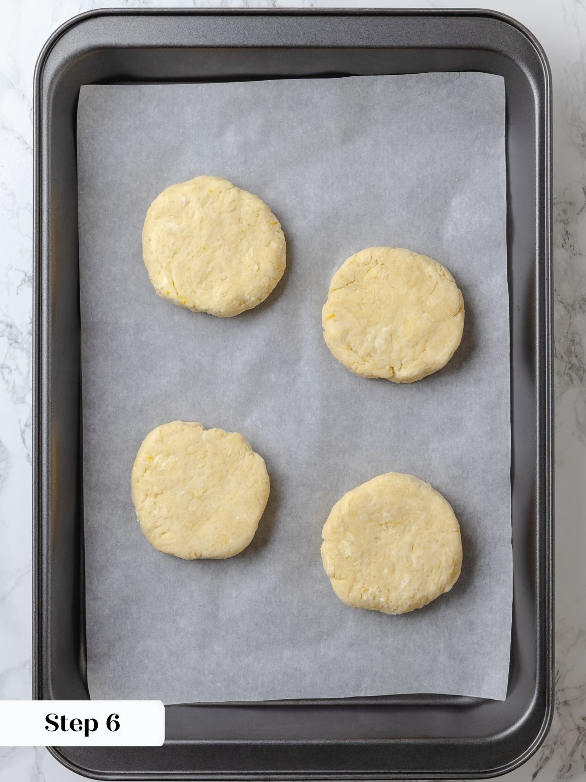 Shortcake biscuits chilling on a lined sheet pan before baking.