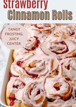 Fluffy cinnamon rolls with swirls of red fruit.