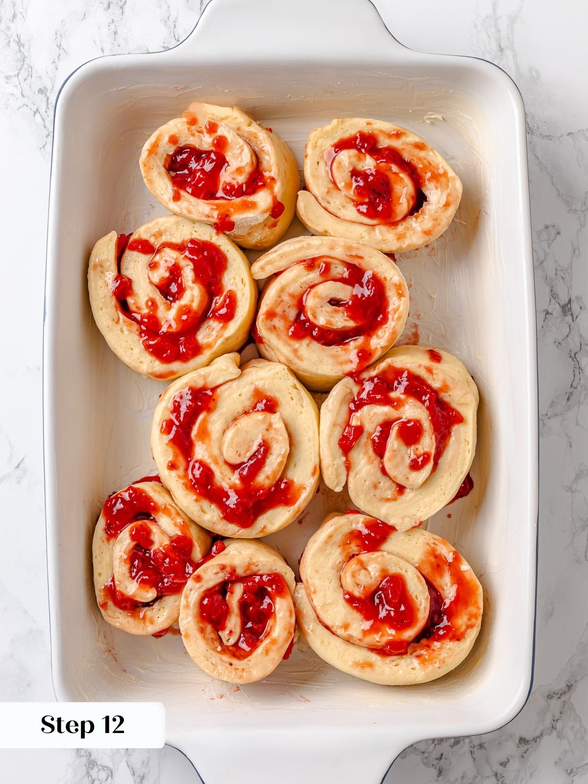 Sliced rolls arranged in pan before final rise.
