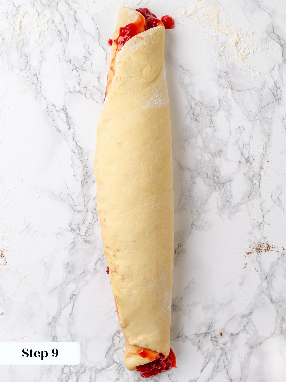 Rolled log of strawberry dough before slicing.