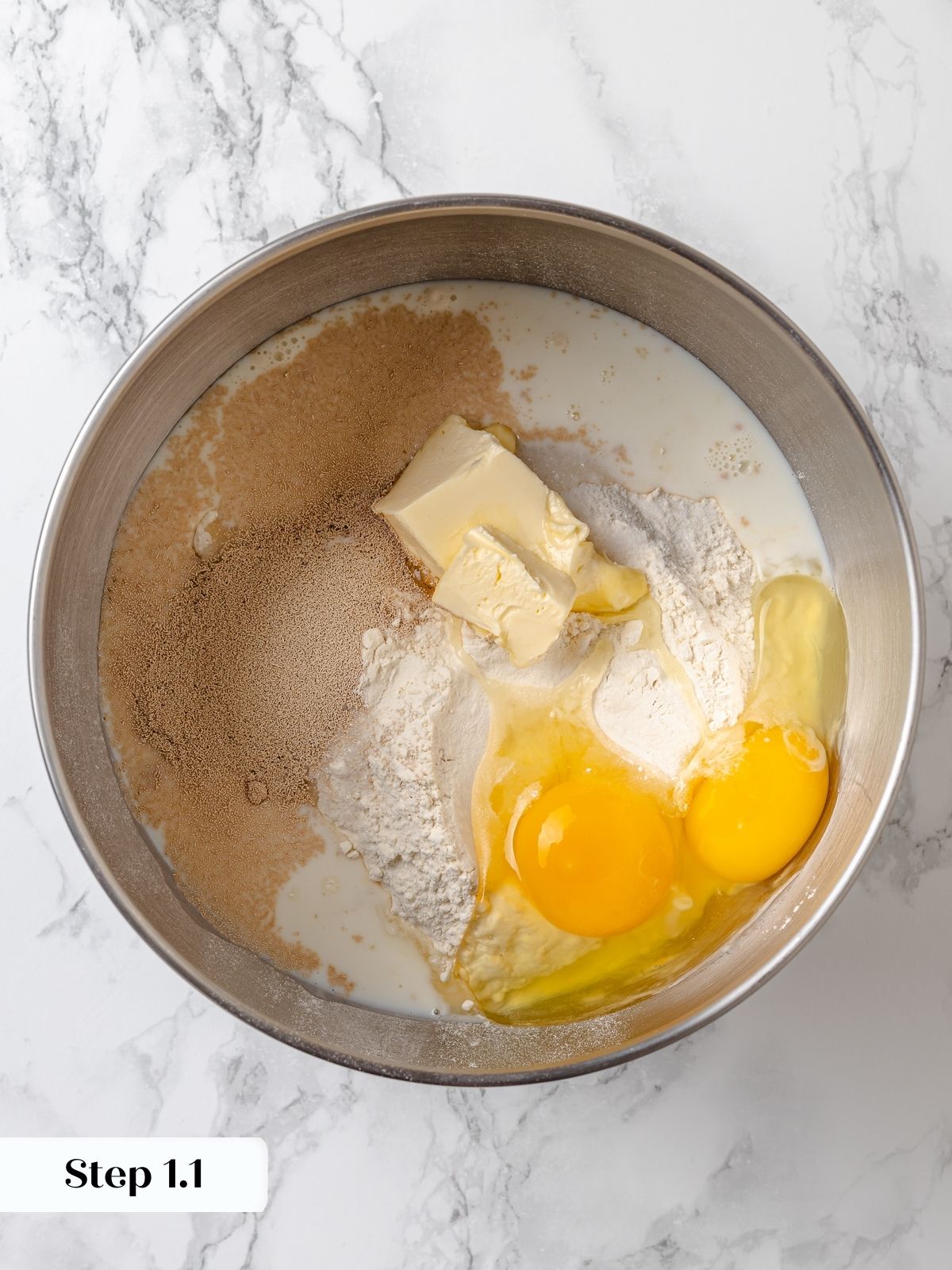 Prepped ingredients for dough in a silver bowl.
