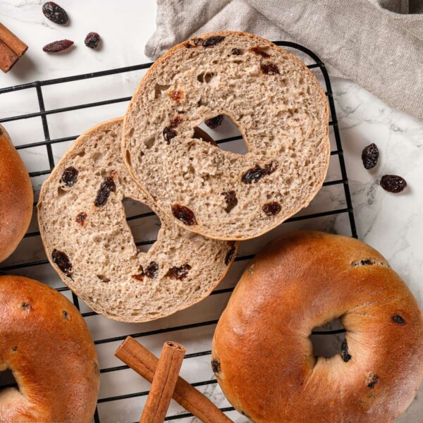 Exposed inside of baked bagel with cinnamon dough and melted raisin pockets.