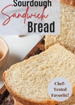 Fluffy sourdough sandwich loaf sliced into even pieces, ready for peanut butter sandwiches or morning toast.