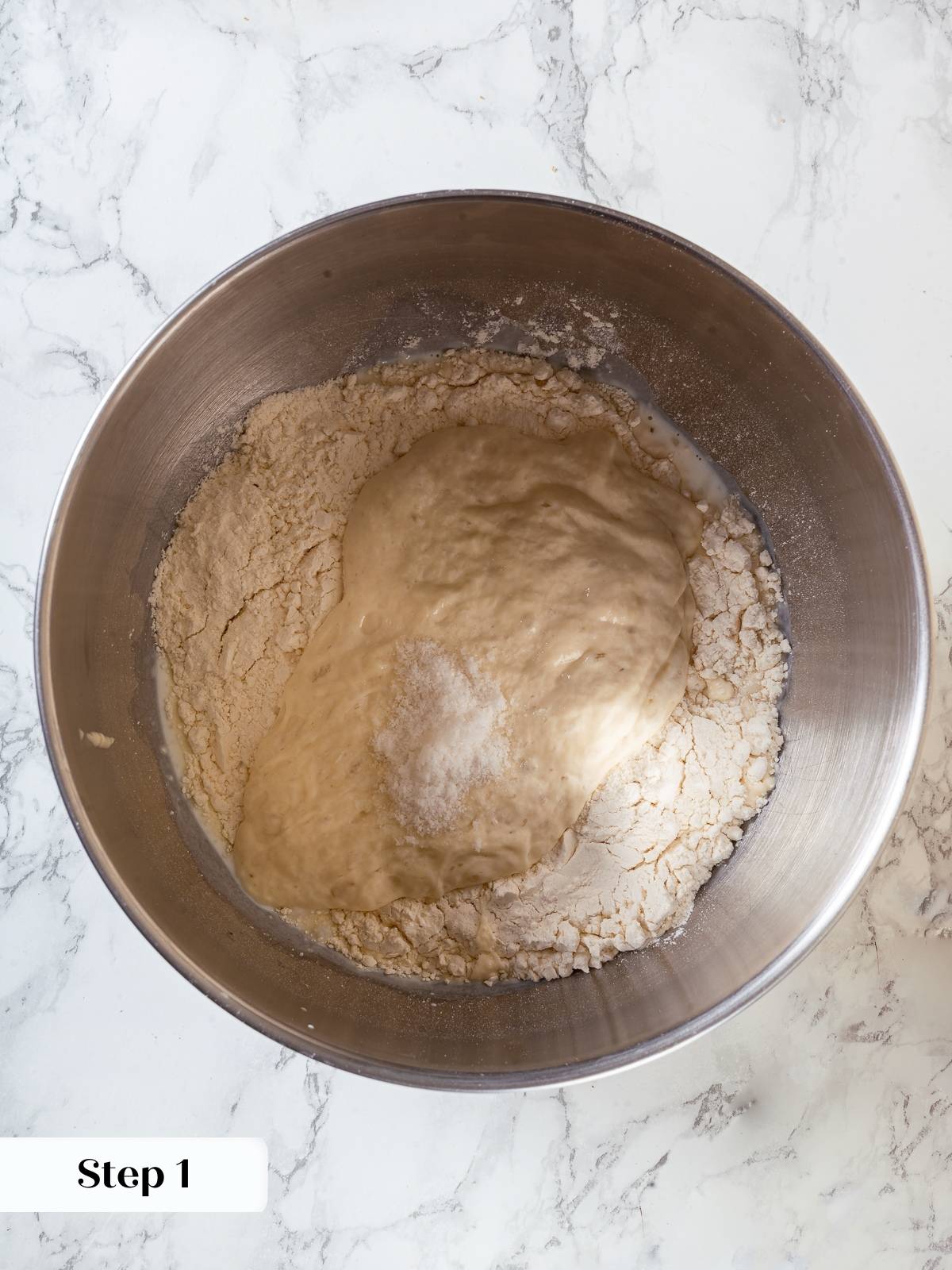 Sourdough sandwich bread ingredients combined in a bowl, ready to form smooth elastic dough.