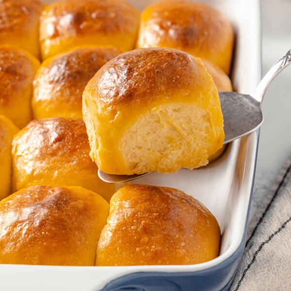 A baking dish filled with golden sweet potato rolls.