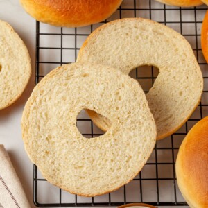 A bagel sliced open to reveal the airy crumb and well developed interior texture.