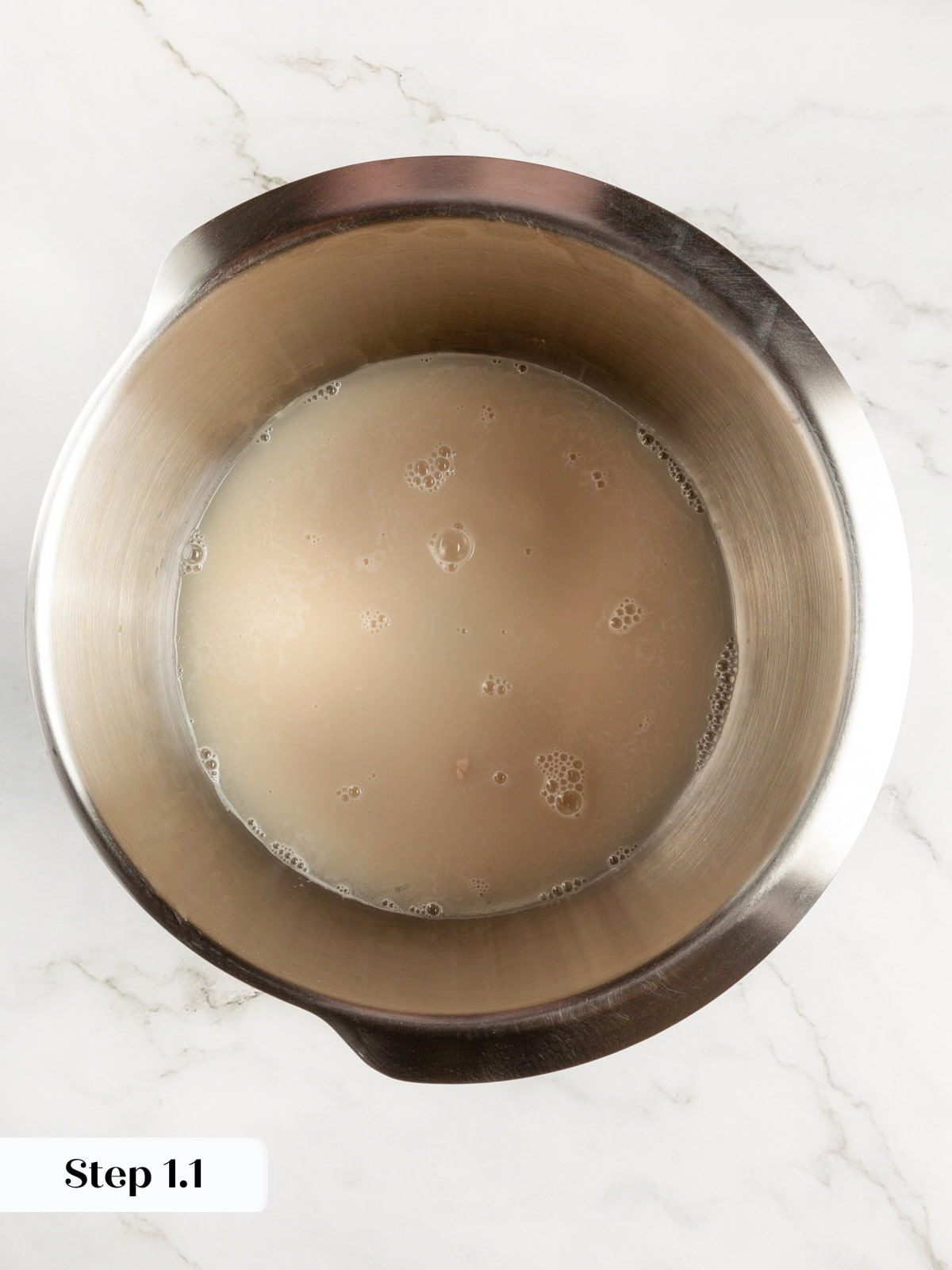 A bowl of yeast dissolving in warm water preparing for the dough mixture.