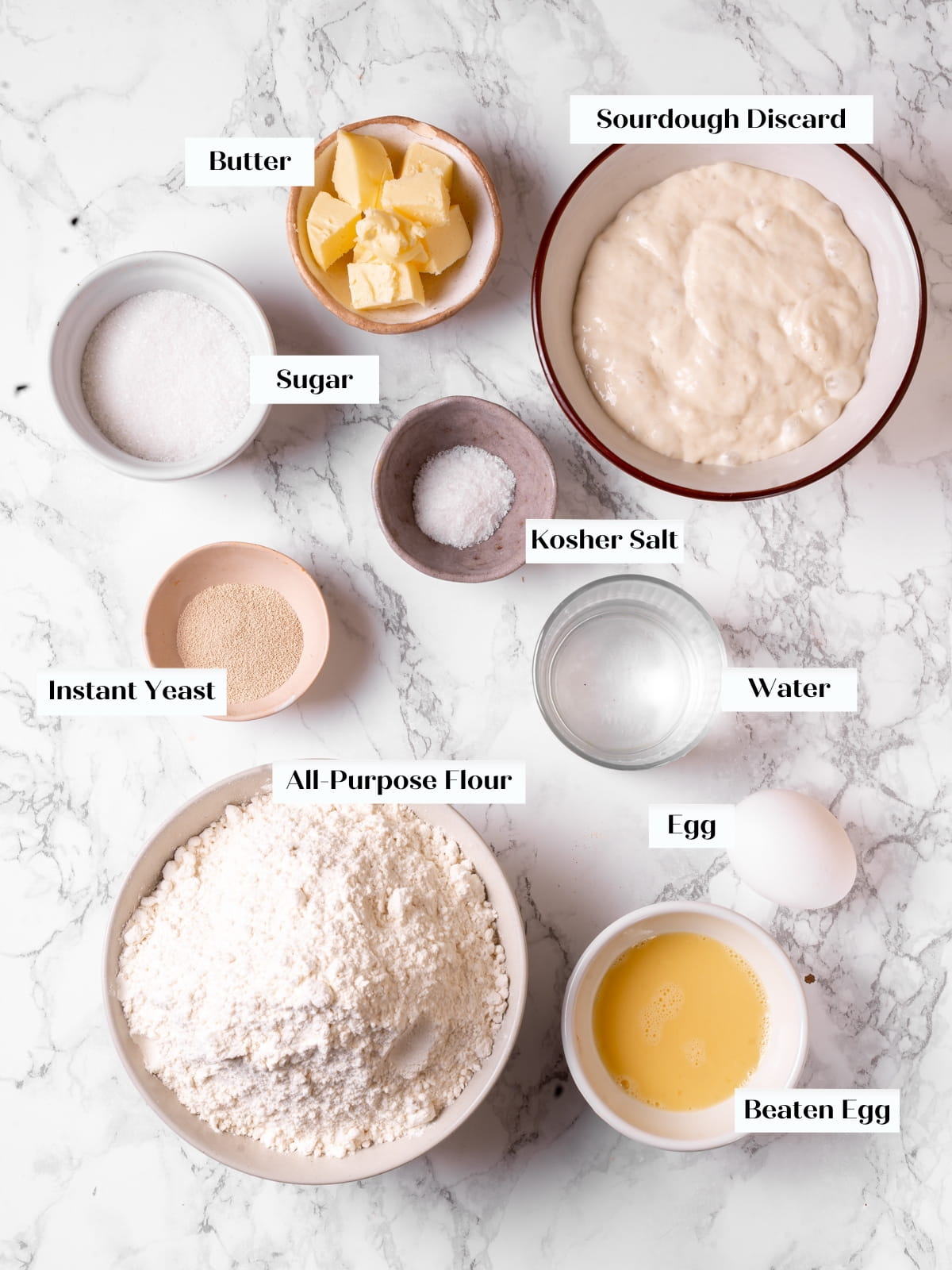 Ingredients for sourdough rolls laid out on a counter ready to be combined.