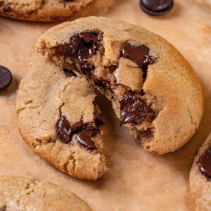 Broken sourdough chocolate chip cookie showing thick interior and melted chocolate pockets.