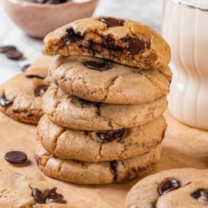 Stack of sourdough chocolate chip cookies with one cookie broken open.